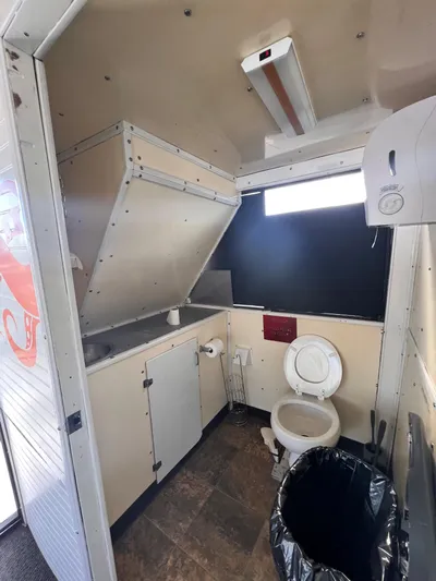 Canyon Odyssey Yacht Photos Pics 1990 Custom 58 Tour Vessel bathroom with sink, toilet, and trash bin.