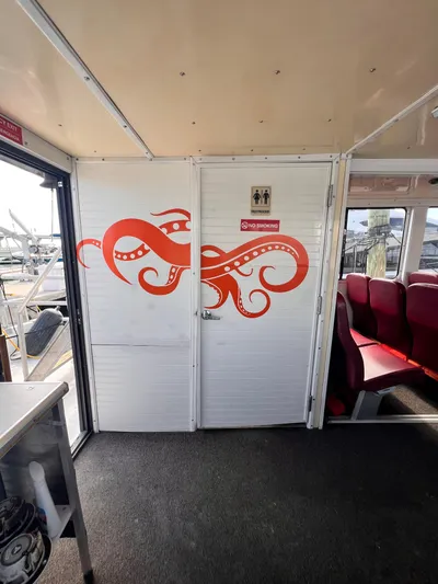 Canyon Odyssey Yacht Photos Pics Interior of 1990 Custom 58 Tour Vessel with octopus mural on restroom door.