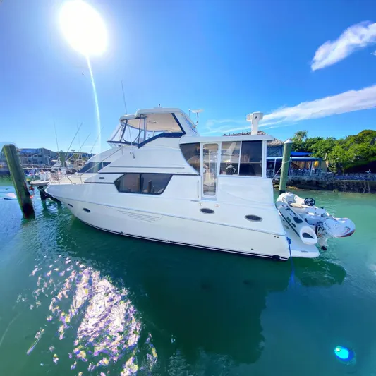 Nauti Boxer Yacht Photos Pics 2003 Silverton 453 Motor Yacht docked in sunny marina, clear blue sky.
