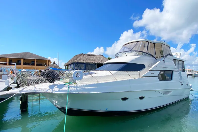 Nauti Boxer Yacht Photos Pics 2003 Silverton 453 Motor Yacht docked under clear blue sky.