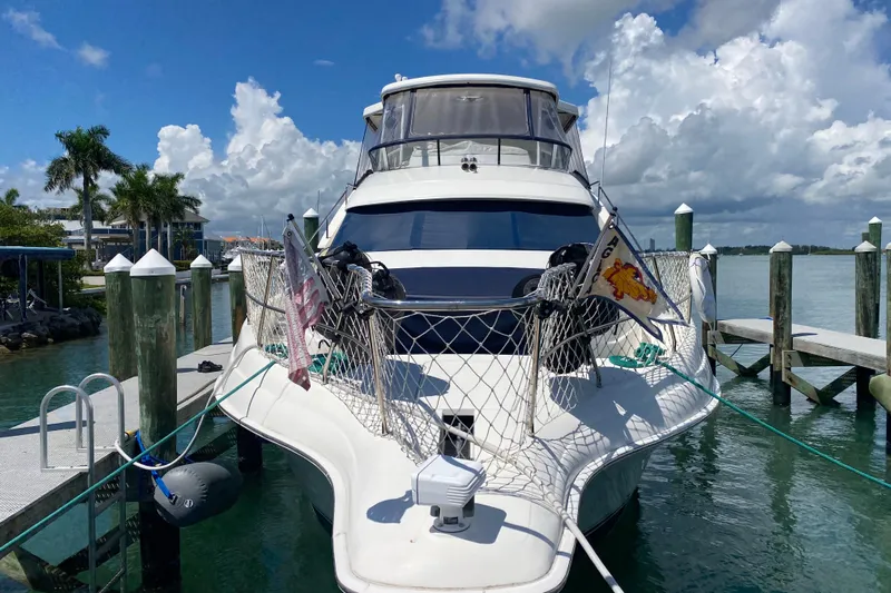 Nauti Boxer Yacht Photos Pics 2003 Silverton 453 Motor Yacht docked at marina under blue sky.