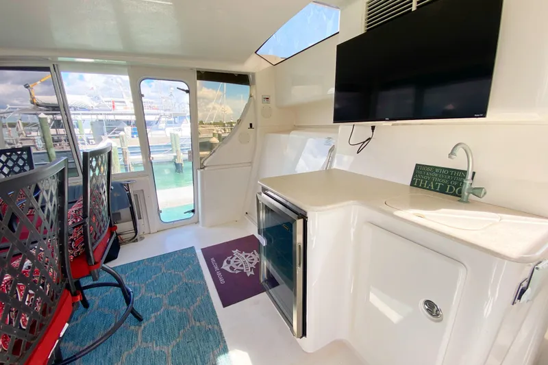 Nauti Boxer Yacht Photos Pics Interior of 2003 Silverton 453 Motor Yacht with seating, TV, and kitchenette.