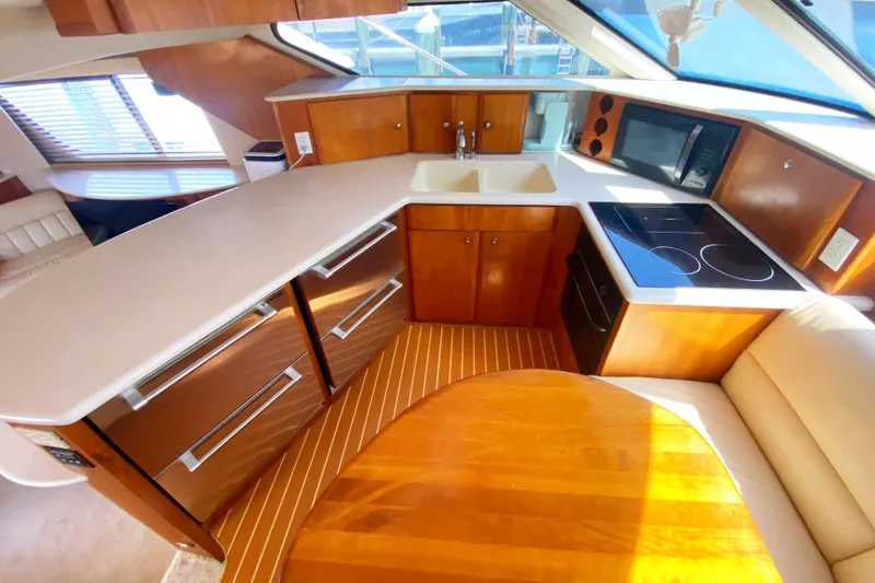 Nauti Boxer Yacht Photos Pics Interior of 2003 Silverton 453 Motor Yacht kitchen with modern appliances and wood finish.