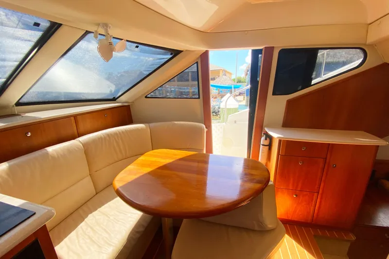 Nauti Boxer Yacht Photos Pics 2003 Silverton 453 Motor Yacht interior with elegant wood finish and comfortable seating.