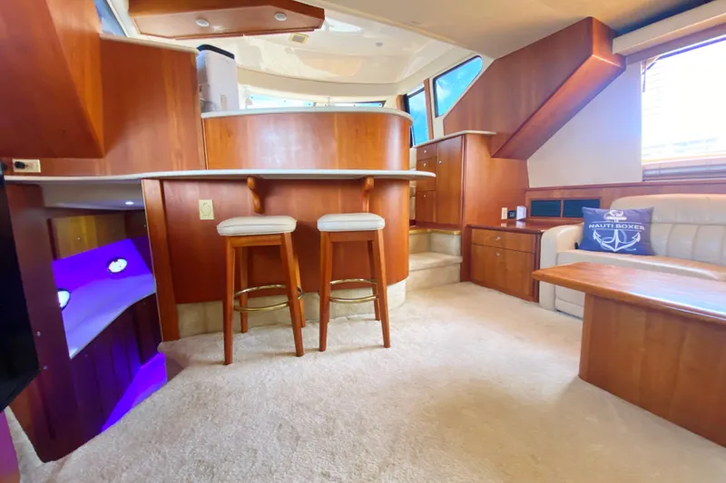 Nauti Boxer Yacht Photos Pics Luxurious interior of 2003 Silverton 453 Motor Yacht with elegant wood finishes and comfortable seating.