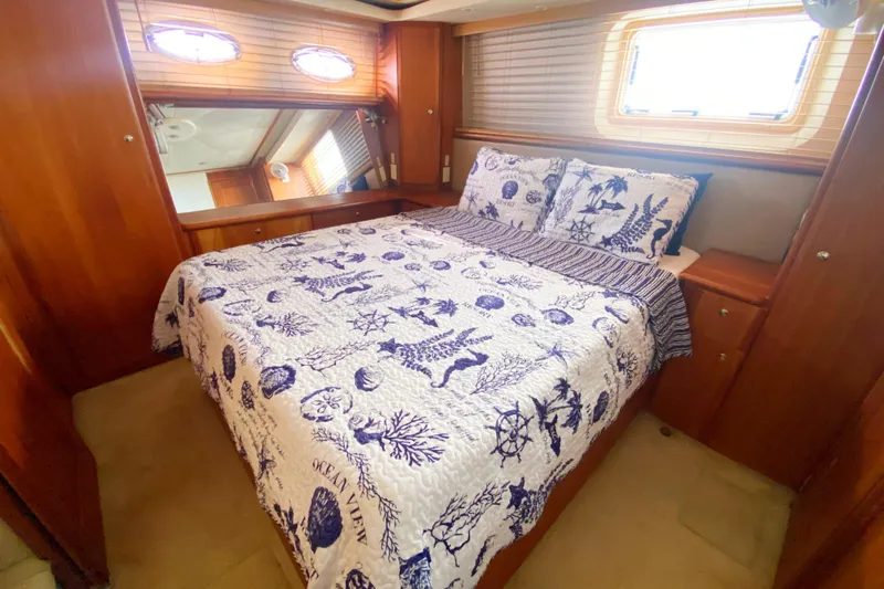 Nauti Boxer Yacht Photos Pics Luxurious bedroom in 2003 Silverton 453 Motor Yacht with nautical-themed bedding.