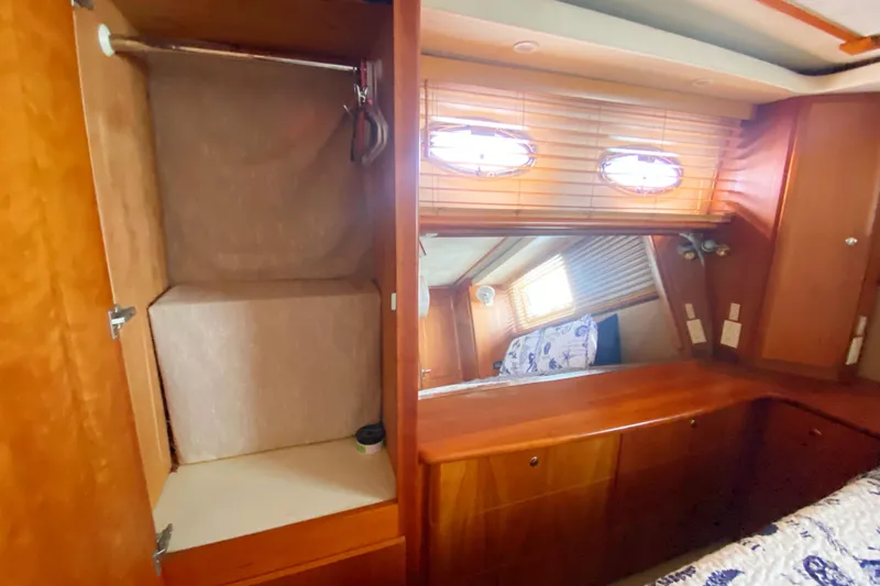 Nauti Boxer Yacht Photos Pics Interior of 2003 Silverton 453 Motor Yacht with wooden cabinetry and porthole windows.