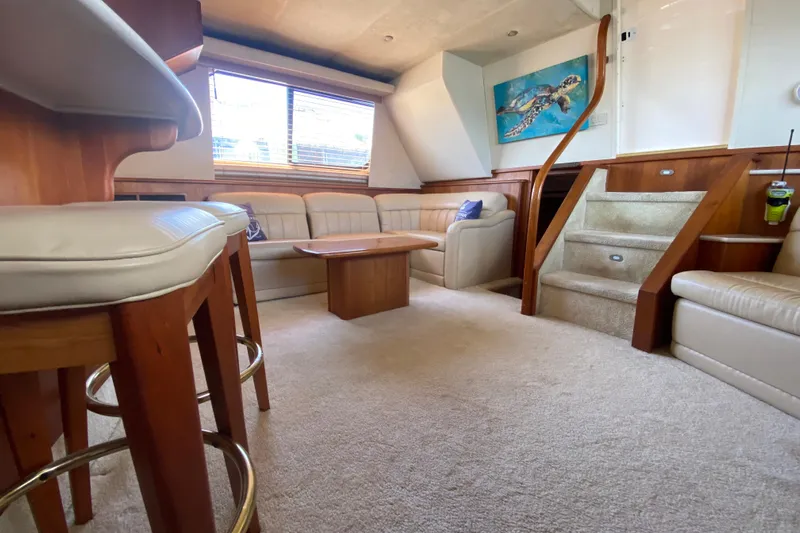 Nauti Boxer Yacht Photos Pics Interior of 2003 Silverton 453 Motor Yacht with plush seating and elegant wood finishes.