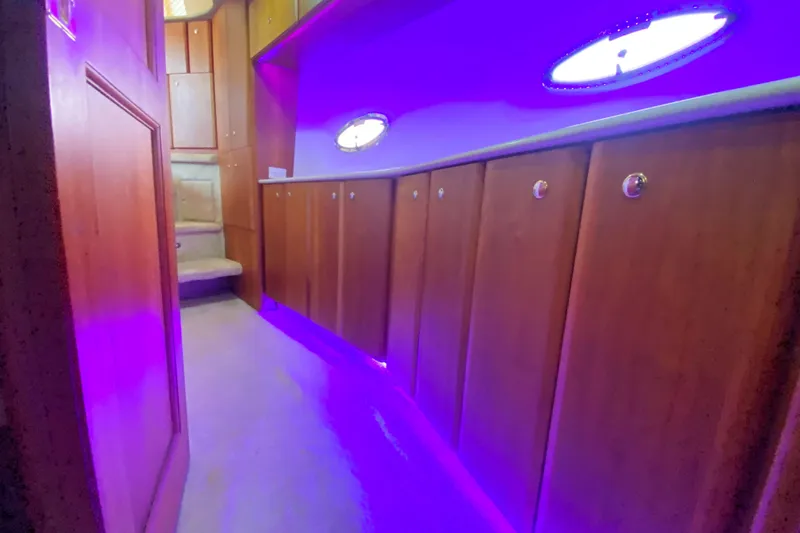 Nauti Boxer Yacht Photos Pics Interior of 2003 Silverton 453 Motor Yacht with purple lighting and wooden cabinetry.