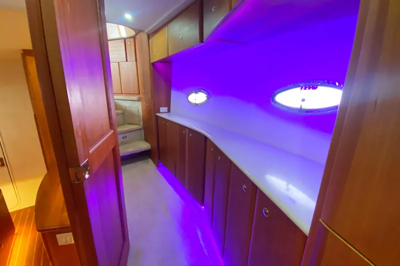 Nauti Boxer Yacht Photos Pics Interior of 2003 Silverton 453 Motor Yacht with purple ambient lighting and wooden cabinetry.