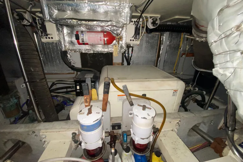 Nauti Boxer Yacht Photos Pics Engine room of 2003 Silverton 453 Motor Yacht with fire extinguisher and equipment.