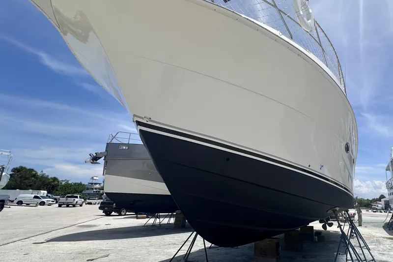 Nauti Boxer Yacht Photos Pics 2003 Silverton 453 Motor Yacht on dry dock under clear blue sky.