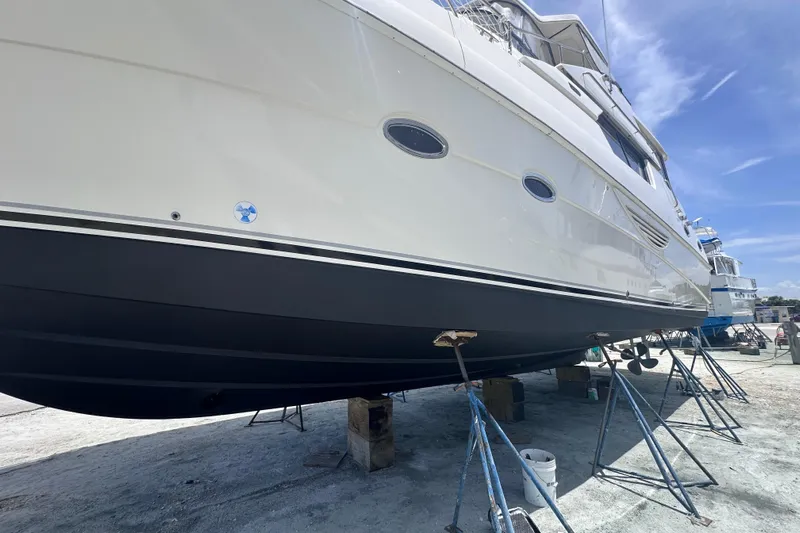 Nauti Boxer Yacht Photos Pics 2003 Silverton 453 Motor Yacht on dry dock, showcasing sleek design and hull details.