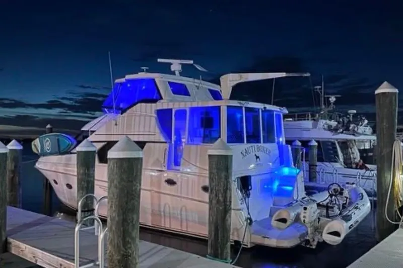 Nauti Boxer Yacht Photos Pics 2003 Silverton 453 Motor Yacht docked at night with blue lighting.