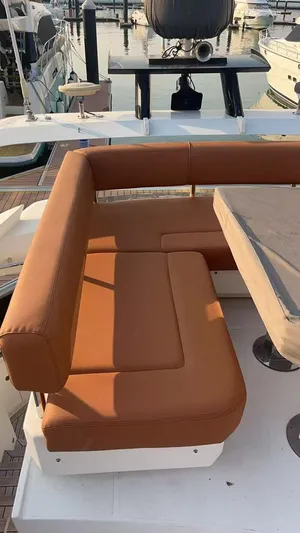  Yacht Photos Pics 2011 Marquis 500 Sport Bridge yacht with brown seating and table on deck.