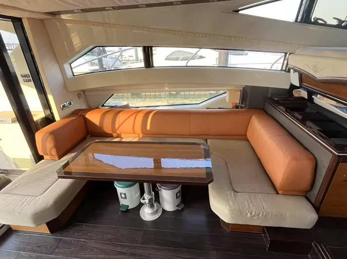  Yacht Photos Pics Luxurious interior of 2011 Marquis 500 Sport Bridge yacht with elegant seating and table.