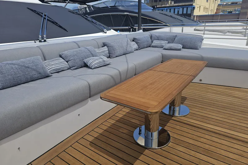 Dream Yacht Photos Pics Luxurious deck seating on 2024 Azimut Grande 32 Metri yacht with wooden table.