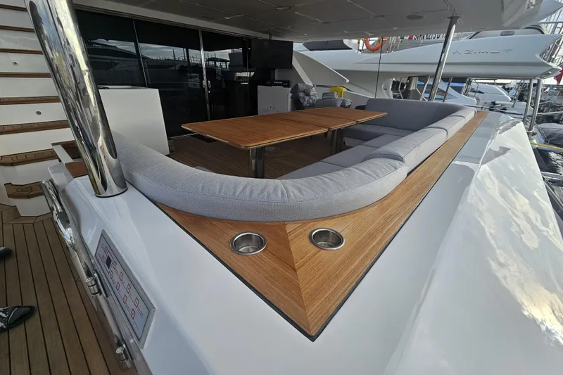 Dream Yacht Photos Pics Luxurious deck seating on 2024 Azimut Grande 32 Metri yacht with wooden table.