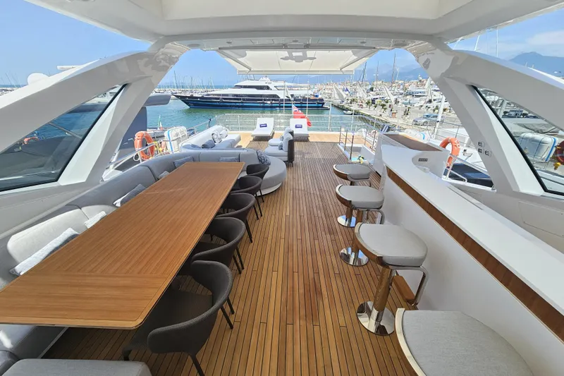 Dream Yacht Photos Pics Luxurious 2024 Azimut Grande 32 Metri yacht deck with elegant seating and dining area.