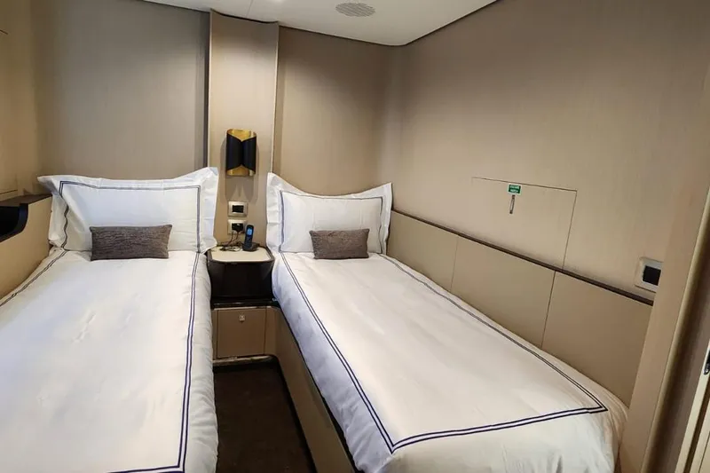 Dream Yacht Photos Pics Luxurious twin bedroom in 2024 Azimut Grande 32 Metri yacht, featuring elegant bedding and modern design.
