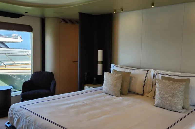 Dream Yacht Photos Pics Luxurious bedroom interior of 2024 Azimut Grande 32 Metri yacht with elegant bedding and window view.