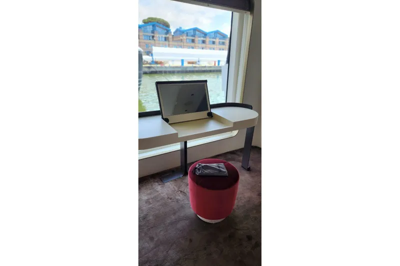 Dream Yacht Photos Pics Modern desk setup on Azimut Grande 32 Metri yacht, 2024 model, with waterfront view.