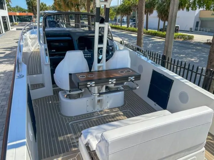  Yacht Photos Pics 2024 Windy SR28 CC boat interior with white seating and wooden table.