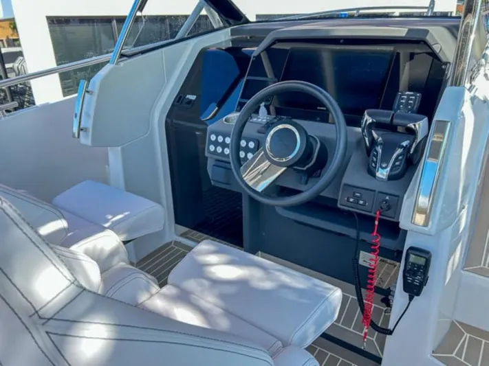  Yacht Photos Pics 2024 Windy SR28 CC boat cockpit with modern steering wheel and control panel.