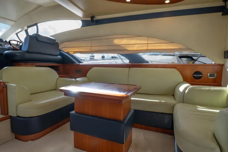 360 Yacht Photos Pics Interior of 2008 Azimut 50 Flybridge yacht with beige seating and wooden table.