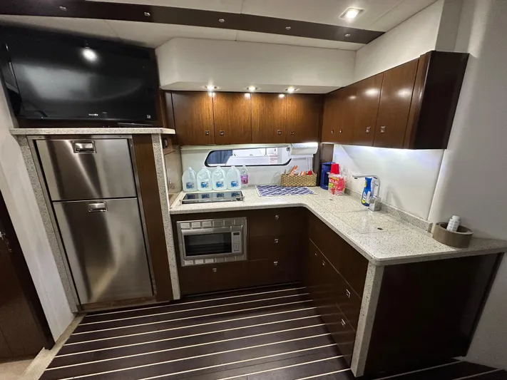 Radical Physics Yacht Photos Pics 2012 Cruisers Yachts 48 Cantius kitchen with modern appliances and sleek cabinetry.