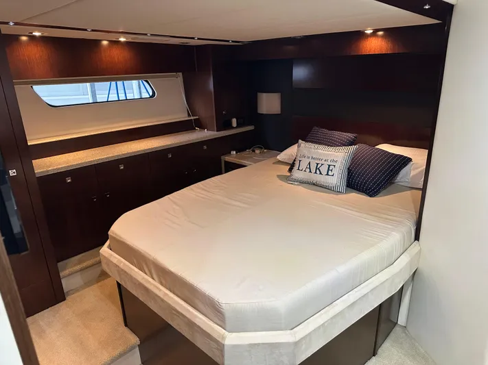 Radical Physics Yacht Photos Pics Luxurious bedroom interior of 2012 Cruisers Yachts 48 Cantius with elegant wood finishes.
