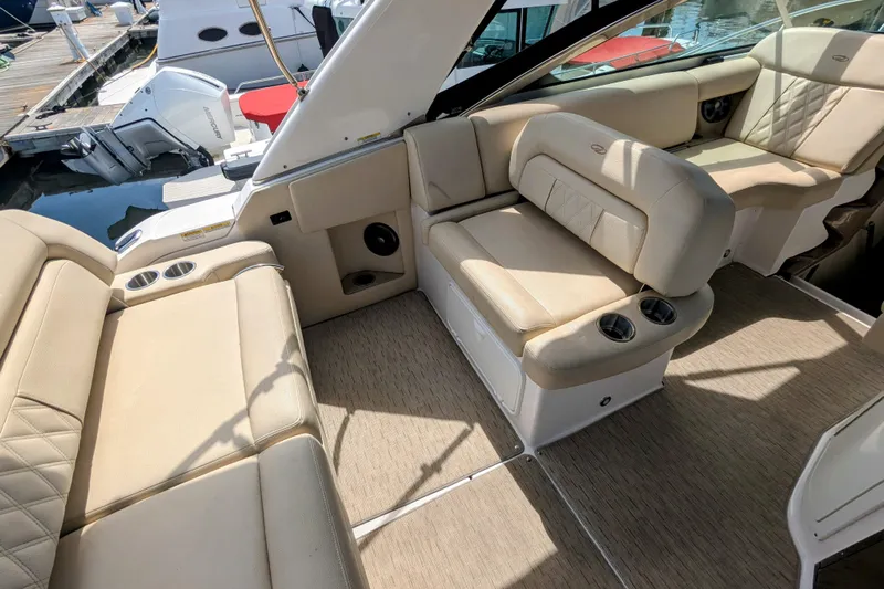  Yacht Photos Pics 2018 Regal 33 XO boat interior with beige seating and cup holders at a marina.