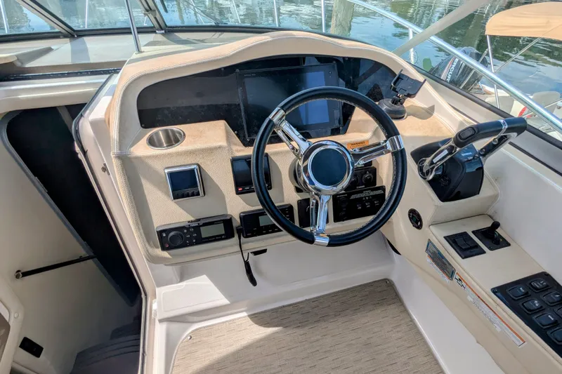  Yacht Photos Pics Cockpit of 2018 Regal 33 XO boat with steering wheel and control panel.