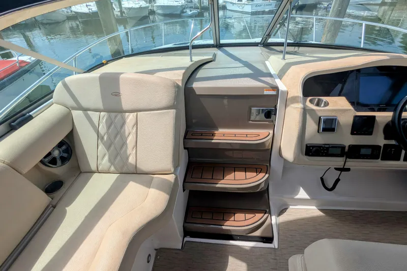  Yacht Photos Pics Interior of 2018 Regal 33 XO boat showing seating and control panel.
