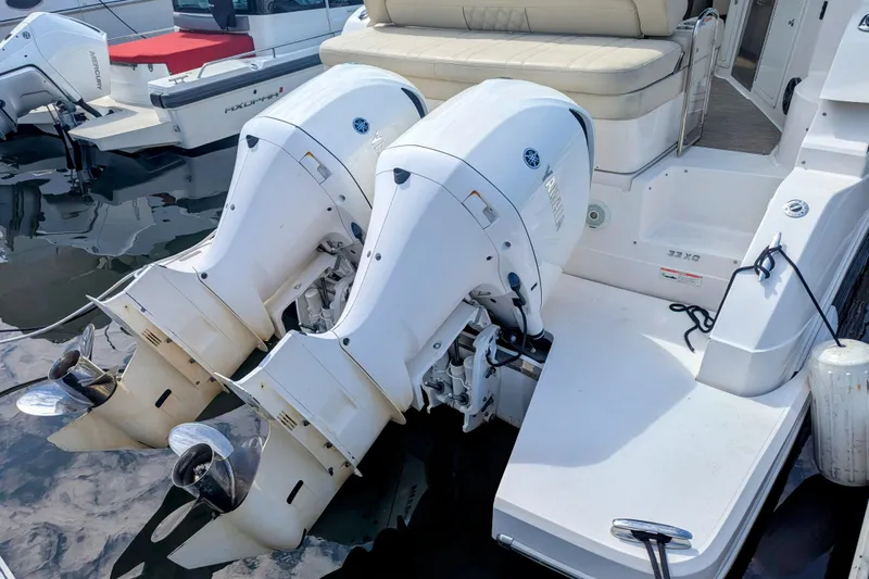  Yacht Photos Pics 2018 Regal 33 XO boat with dual outboard engines docked at marina.