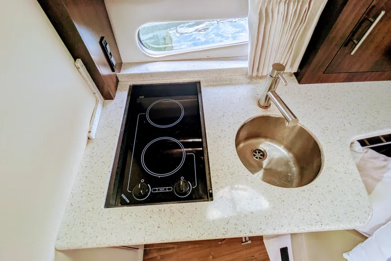  Yacht Photos Pics 2018 Regal 33 XO yacht kitchen with stove and sink.