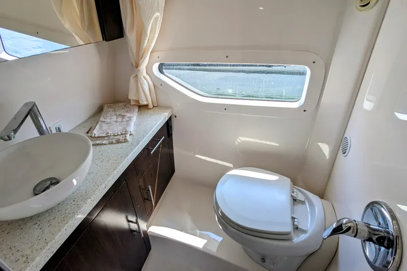  Yacht Photos Pics Luxurious bathroom in 2018 Regal 33 XO yacht with modern fixtures and window view.