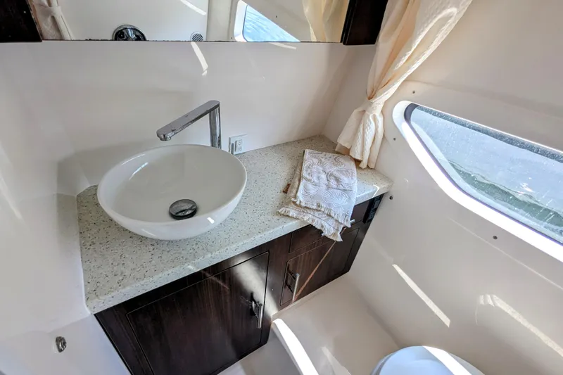  Yacht Photos Pics Luxurious bathroom interior of 2018 Regal 33 XO yacht with modern sink and window view.