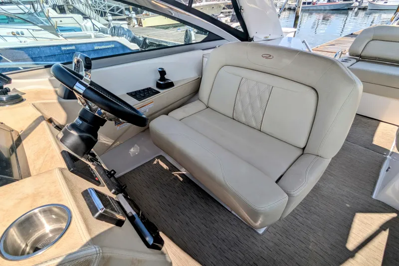  Yacht Photos Pics 2018 Regal 33 XO boat interior with steering wheel and beige seating.
