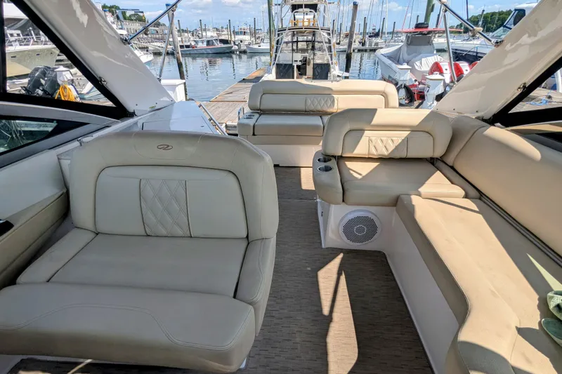  Yacht Photos Pics Luxurious interior of 2018 Regal 33 XO yacht at marina, featuring beige seating.