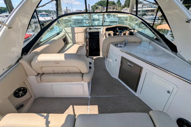  Yacht Photos Pics 2018 Regal 33 XO boat interior with seating, kitchenette, and helm at marina.