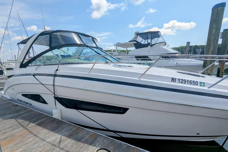  Yacht Photos Pics 2018 Regal 33 XO boat docked at marina under clear blue sky.