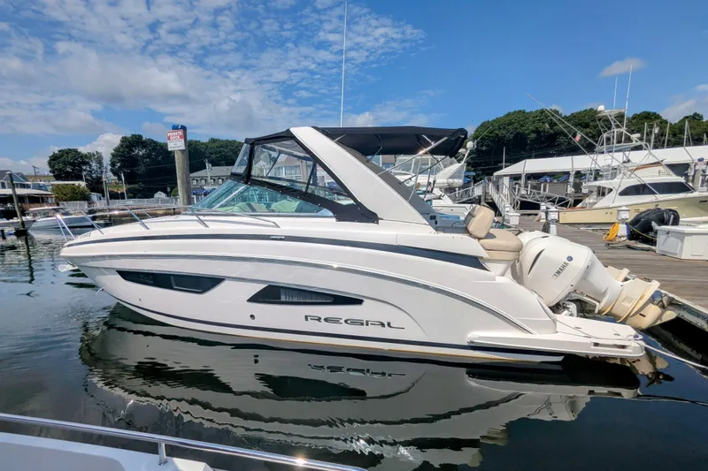  Yacht Photos Pics 2018 Regal 33 XO boat docked at marina under clear blue sky.