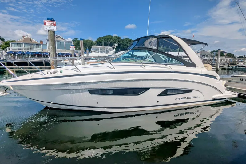  Yacht Photos Pics 2018 Regal 33 XO boat docked at a marina under a clear blue sky.