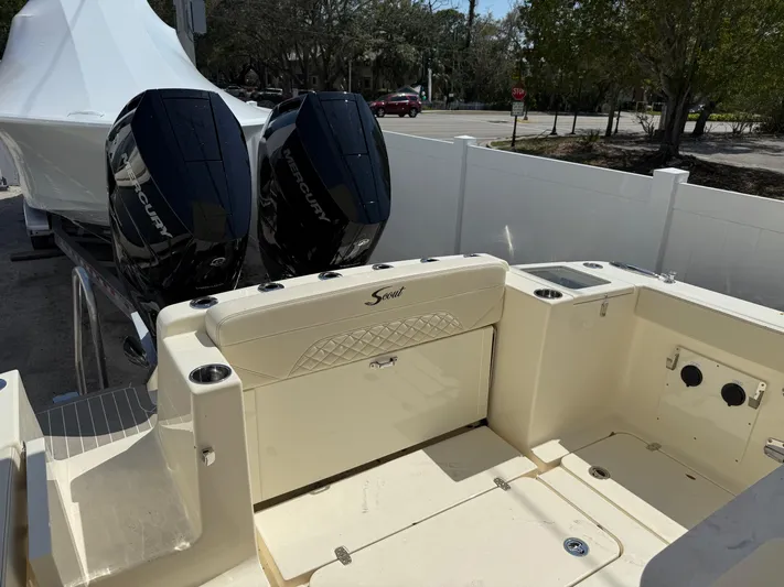 Yacht Photos Pics 2025 Scout 330 LXF boat with dual outboard engines, parked outdoors.