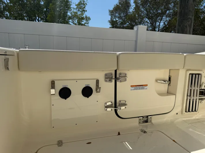  Yacht Photos Pics 2025 Scout 330 LXF boat interior with utility access panel and fittings.
