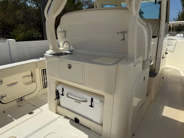  Yacht Photos Pics 2025 Scout 330 LXF boat interior with sink and storage area.