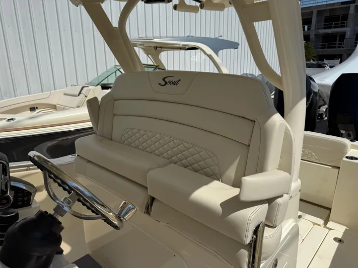  Yacht Photos Pics 2025 Scout 330 LXF boat interior with luxurious seating and steering wheel.