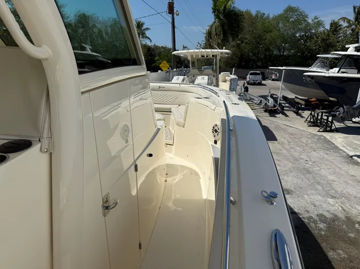  Yacht Photos Pics 2025 Scout 330 LXF boat, sleek design, docked outdoors, sunny day.