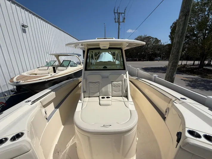  Yacht Photos Pics 2025 Scout 330 LXF boat with sleek design and spacious seating.